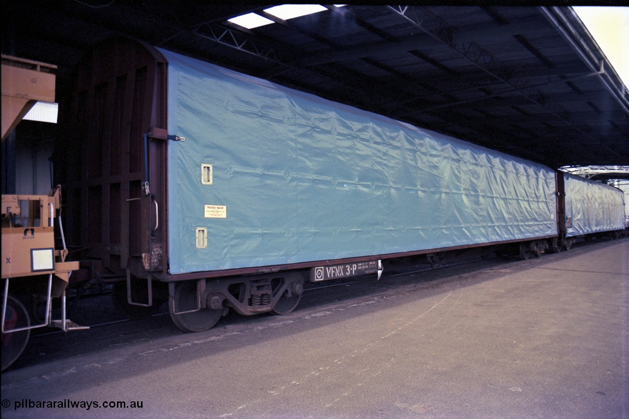 162-3-13
Melbourne Yard, No.10 Goods Shed, PTC Open Day, V/Line broad gauge VFNX type bogie tarpaulin covered roll paper waggon VFNX 3 with new looking blue tarpaulin, coupled to sister waggon, built new in May 1979 at Newport Workshops.
Keywords: VFNX-type;VFNX3;Victorian-Railways-Newport-WS;