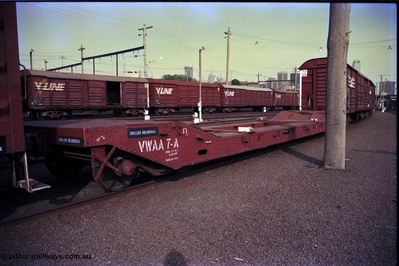 162-3-19
Melbourne Yard, V/Line broad gauge VWAA type bogie well waggon VWAA 7, built at Newport Workshops January 1913 as QB type bogie well - boiler transport waggon, fitted with container anchors which were fitted in 1975, behind it are VLCX, VBBF and VLDX type bogie louvre vans, VLCX 183, VBBF 124 and VLDX 1.
Keywords: VWAA-type;VWAA7;Victorian-Railways-Newport-WS;QB-type;