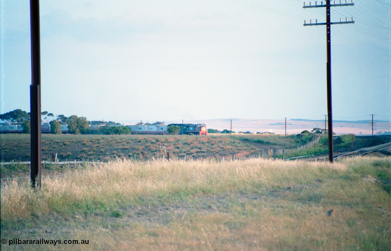 163-01
Bank Box Loop, broad gauge down V/Line Adelaide bound good train rounding the curve on approach behind a third series X class and Australian National BL class.
