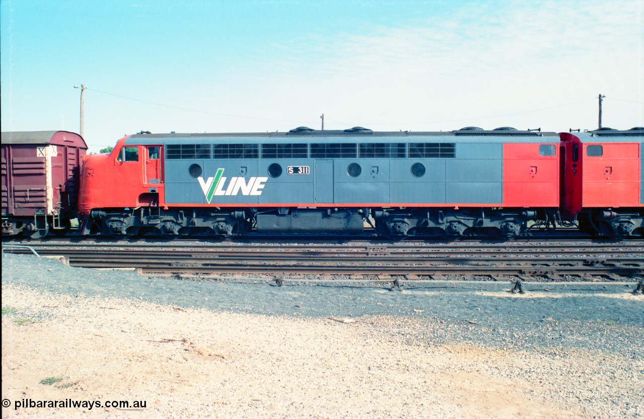 163-07
Seymour station yard, stabled V/Line down broad gauge Wodonga goods train in the rationalised yard behind the classic back to back pair of streamlined Bulldogs, S classes S 311 'Sir Ferdinand von Mueller' Clyde Engineering EMD model A7 serial 60-228 with a rake of louvre vans leading, side view.
Keywords: S-class;S311;Clyde-Engineering-Granville-NSW;EMD;A7;60-228;bulldog;