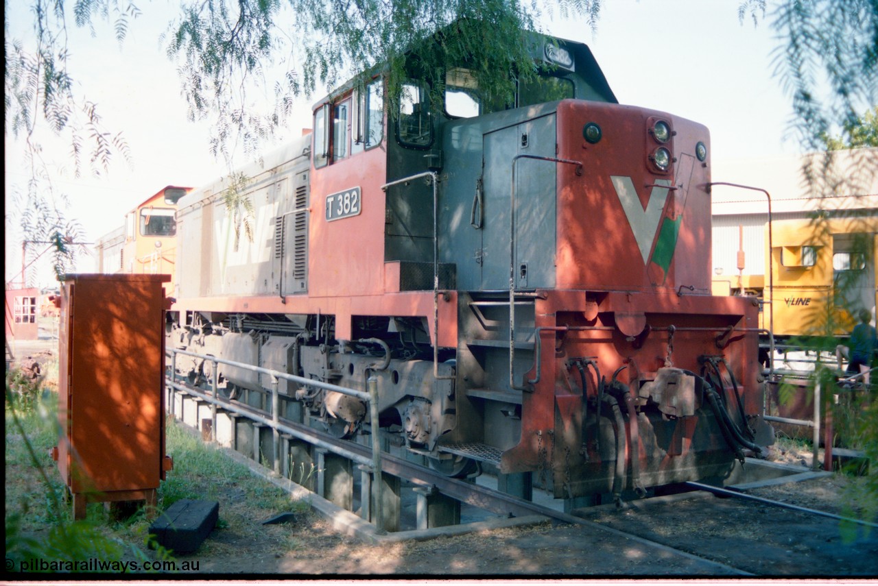 163-16
Seymour loco depot turntable roads, V/Line broad gauge T class loco T 382 Clyde Engineering EMD model G8B serial 64-337 sits over the brake pit road couple to a Y class, turntable in the background.
Keywords: T-class;T382;Clyde-Engineering-Granville-NSW;EMD;G8B;64-337;