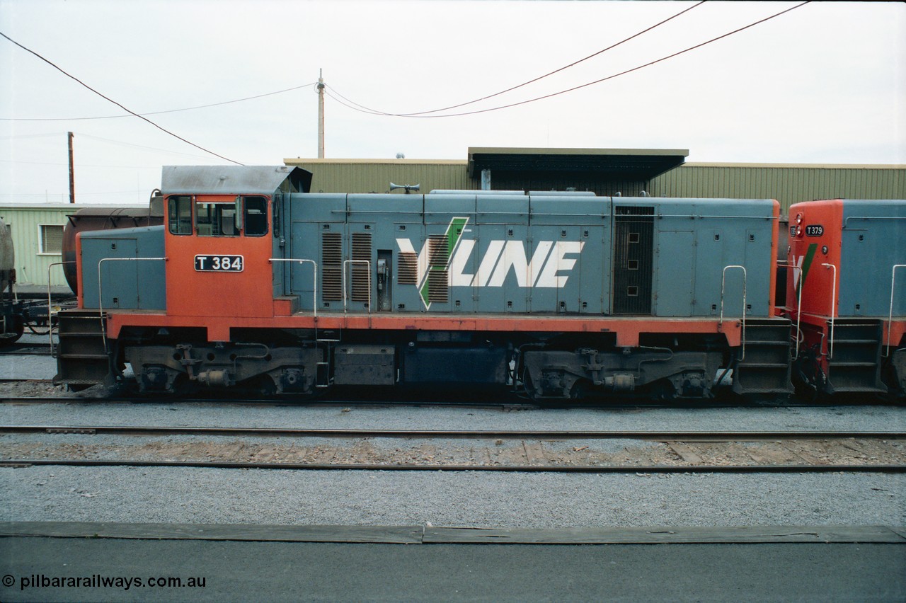 163-22
Shepparton station view from platform with stabled V/Line broad gauge T class locomotive T 384 Clyde Engineering EMD model G8B serial 64-339, goods shed behind loco, side view.
Keywords: T-class;T384;Clyde-Engineering-Granville-NSW;EMD;G8B;64-339;