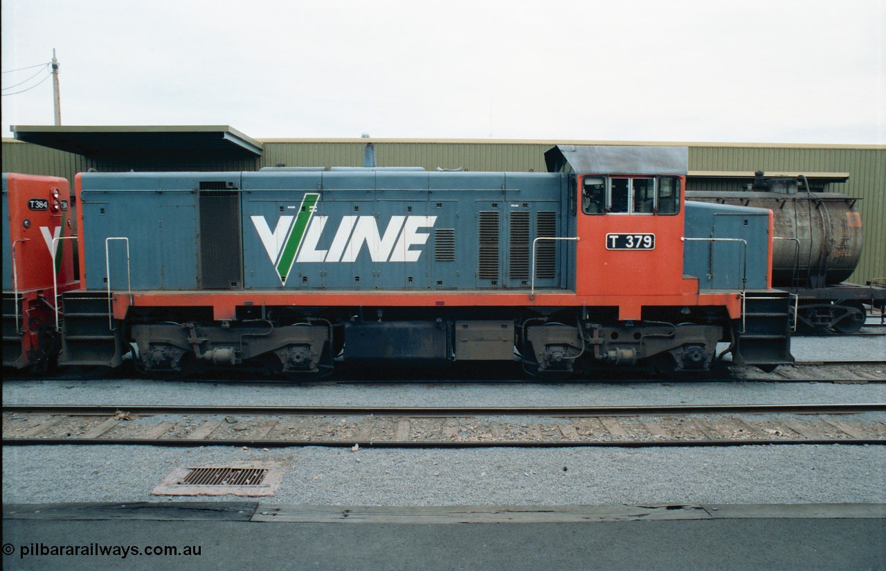 163-23
Shepparton station view from platform with stabled V/Line broad gauge T class locomotive T 379 Clyde Engineering EMD model G8B serial 64-334, goods shed behind loco, side view.
Keywords: T-class;T379;Clyde-Engineering-Granville-NSW;EMD;G8B;64-334;