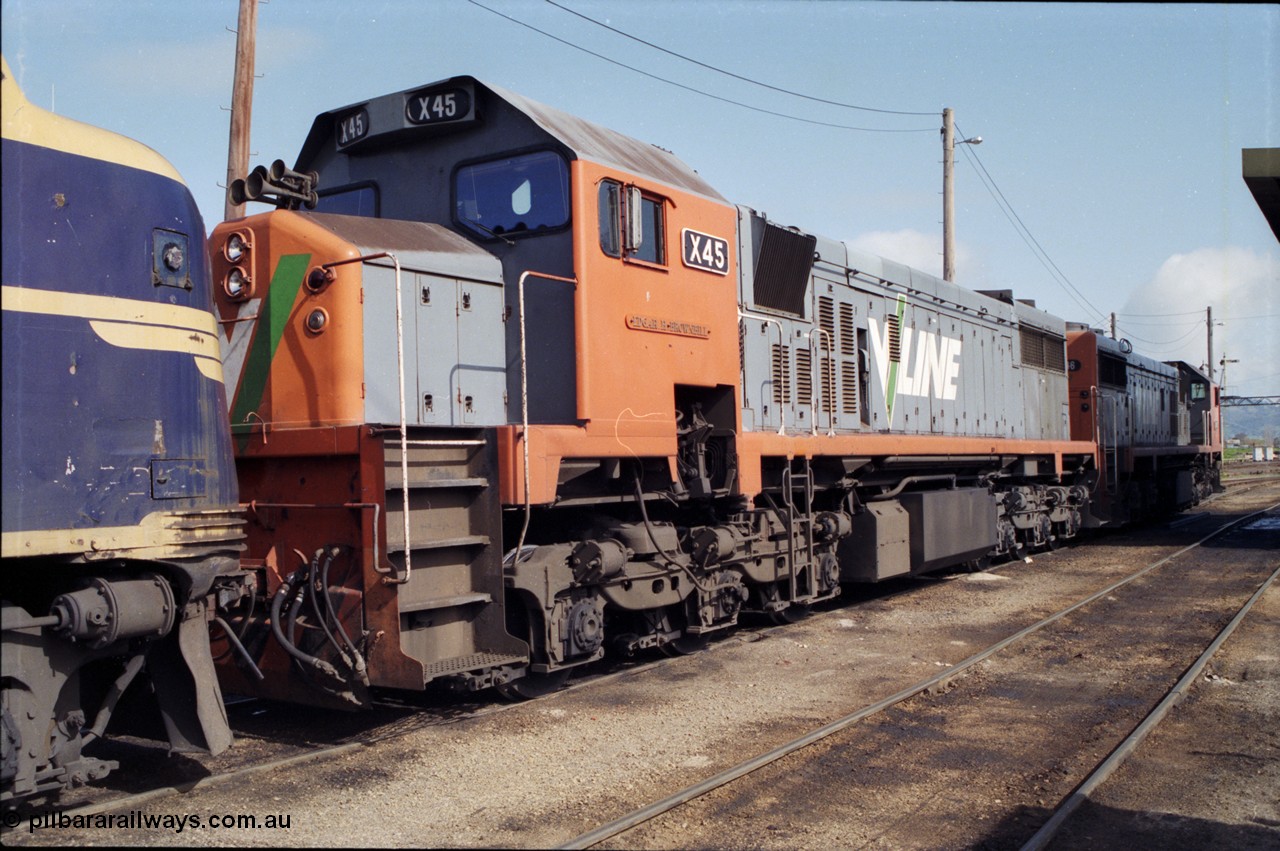 165-05
Wodonga loco depot, V/Line broad gauge X class locomotives X 45 'Edgar H Brownbill' Clyde Engineering EMD model G26C serial 75-792 and X 46 serial 75-793 stand next to the fuel point with B class B 75 waiting to run the Sunday evening Up Albury slab steel train 9334 to Long Island.
Keywords: X-class;X45;Clyde-Engineering-Rosewater-SA;EMD;G26C;75-792;