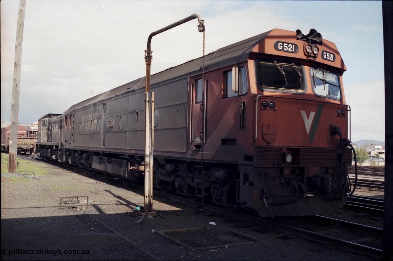 165-10
Albury loco depot, standard gauge V/Line G class G 521 Clyde Engineering EMD model JT26C-2SS serial 85-1234 with a T class, T 411?, signal box behind T class, stand pipe, turntable to left of frame.
Keywords: G-class;G521;Clyde-Engineering-Rosewater-SA;EMD;JT26C-2SS;85-1234;