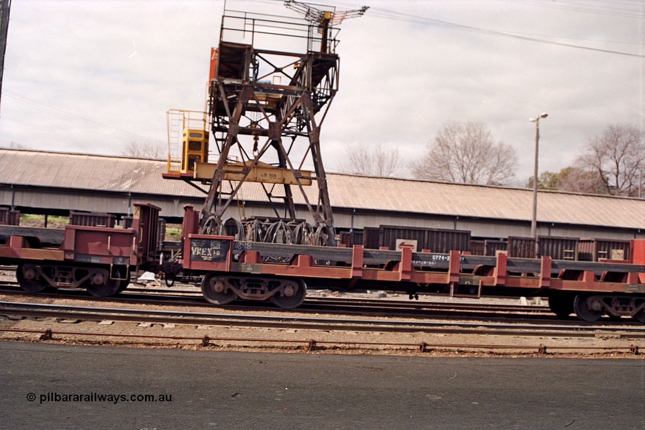 166-00
Albury yard view with trans-shipping gantry crane and shed, V/Line broad gauge bogie slab steel waggons of the VKEX type, VKEX 1 started life as an ELX built at the North Melbourne Workshops in December 1979, and NSWSRA NRJY type in the background, skewed.
Keywords: VKEX-type;VKEX1;ELX-type;