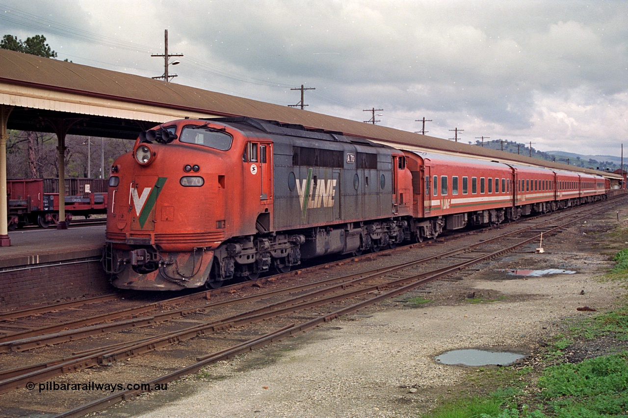 166-03
Albury, V/Line broad gauge A class A 70 Clyde Engineering EMD model AAT22C-2R serial 84-1187 rebuilt from B class B 70 Clyde Engineering EMD model ML2 serial ML2-11 arrives at the Victorian platform with an empty carriage set to work an up passenger train to Melbourne.
Keywords: A-class;A70;Clyde-Engineering-Rosewater-SA;EMD;AAT22C-2R;84-1187;rebuild;bulldog;