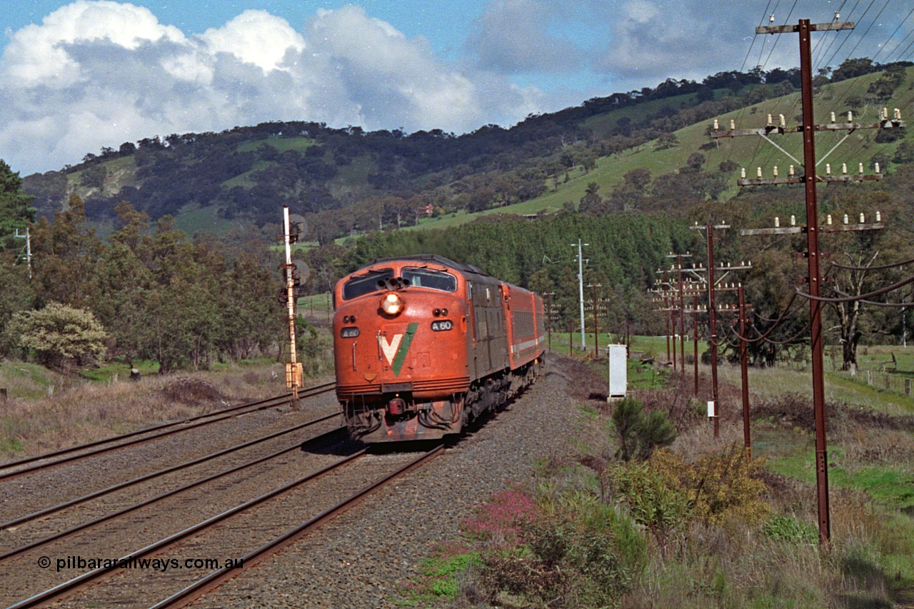 166-21
Kilmore East, down V/Line broad gauge passenger train powered by Bulldog rebuild A class leader A 60 Clyde Engineering EMD model AAT22C-2R serial 84-1184 rebuilt from B class B 60 Clyde Engineering EMD model ML2 serial ML2-1 with N set blasts upgrade, the signal post on the standard gauge line is the Kilmore East home for the broad gauge crossing into the Apex Quarry Siding and numbered KME/6.
Keywords: A-class;A60;Clyde-Engineering-Rosewater-SA;EMD;AAT22C-2R;84-1184;rebuild;bulldog;