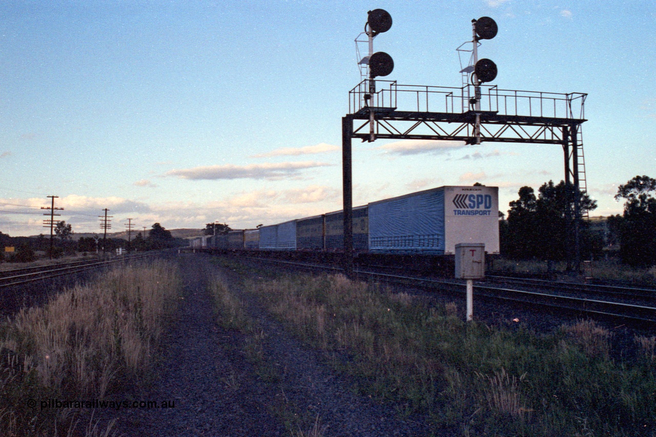 167-11
Wallan Loop, north end of standard gauge crossing loop, north bound goods end of train under signal gantry looking north, trailing view.

