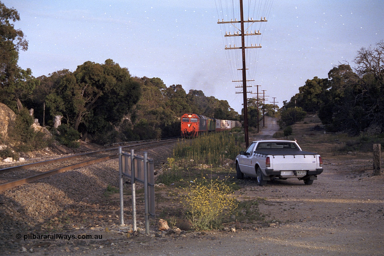 168-07
Bank Box Loop, down V/Line broad gauge goods train to Adelaide with G class G 540 Clyde Engineering EMD model JT26C-2SS serial 89-1273 and Australian National 700 class 704 AE Goodwin ALCo model DL500G serial G6059-2 power away from the crossing loop at the Ironbark Road grade crossing.
