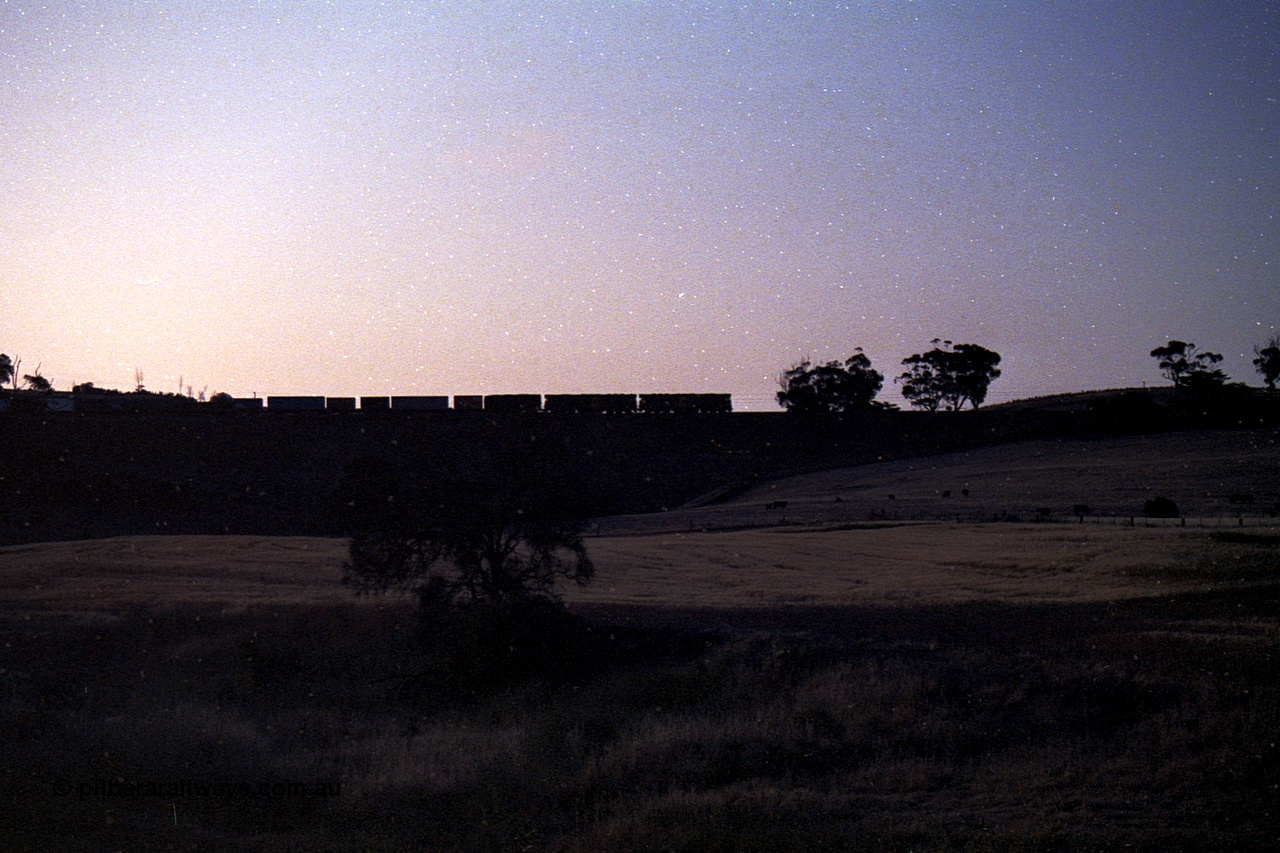 168-17
Rowsley, double broad gauge Australian National BL class units power another Adelaide bound freighter.
