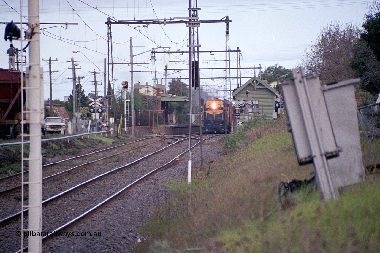 169-01
Spotswood, distant view looking towards Newport, former Victorian Railways and ex. Australian - Portland Cement broad gauge T class locomotive T 413 Clyde Engineering EMD model G8B serial 56-107 leads an up special at the platform, signal box on the right and banner signal U6 on the left with dwarf signal 8 in-between running lines.
Keywords: T-class;T413;Clyde-Engineering-Granville-NSW;EMD;G8B;56-107;