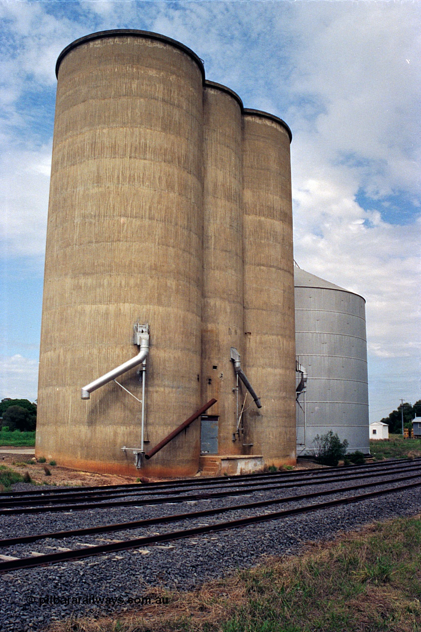 170-06
Dookie, track view from former platform, elevation of Williamstown style silo complex with steel annex, load-out spouts, weighbridge hut in the background to the right of silos.
