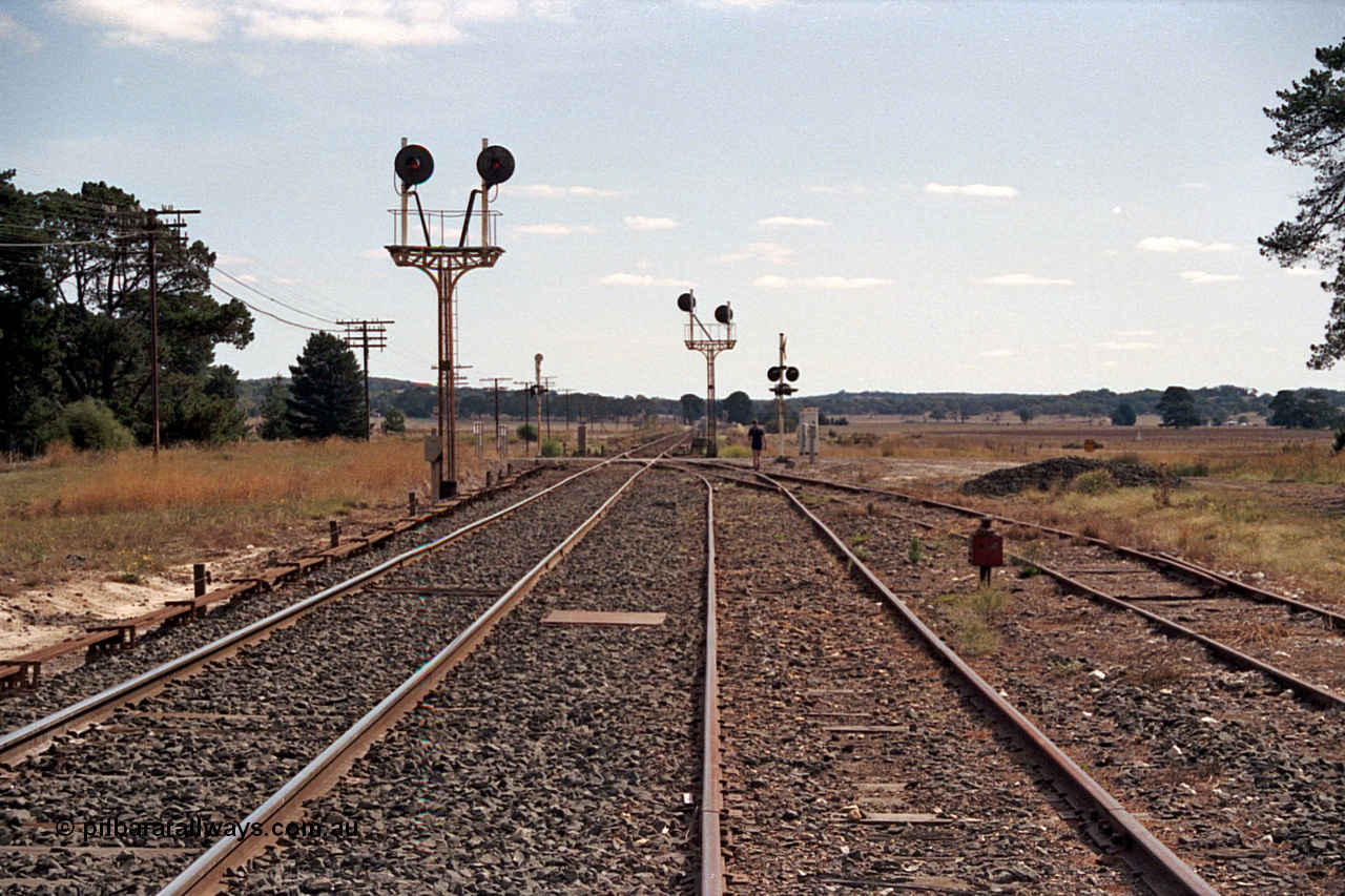 171-07
Trawalla station yard overview, looking towards Ararat, searchlight Signal Post 5 facing camera with left light Home No. 1 Road to Main Line and the right Home No. 2 Road to Main Line, Signal Post 6 facing away, point rodding, No.3 Road catch point and indicator, Waterloo Road grade crossing.
