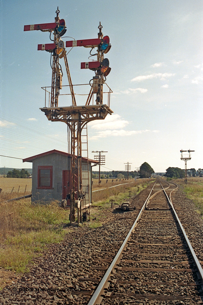 171-14
Trawalla station yard overview, looking towards Ararat, Down Home semaphore Signal Post 2 top arm on left hand Doll Home for Main Line to No. 1 Road to Post 5, bottom arm on left hand Doll Calling-on from Main Line to No.1 Road towards Post 5. Top arm on right hand Doll for Main Line to No. 2A Road to Post 4 and bottom Doll for Main Line to No. 2A Road towards Post 4. Motorised points, machine and electric interlocking room, semaphore Signal Post 3 facing up trains.
