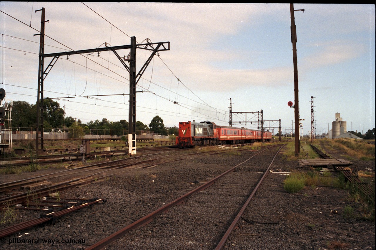 172-06
Sunshine, broad gauge down passenger service lead by a V/Line P class P 17 Clyde Engineering EMD model G18HBR serial 84-1216 rebuilt from T 327 Clyde Engineering EMD model G8B serial 56-78 hauling a 4 car H set, another point of this image is the amount of point rodding running around the place and the standard gauge platform in the background.
Keywords: P-class;P17;Clyde-Engineering-Somerton-Victoria;EMD;G18HBR;84-1216;rebuild;