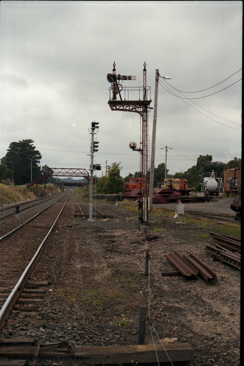 172-22
Ballarat East, semaphore signal post 3, looking east towards Warrenheip, new electric colour light signal post stands at the end of the former Eureka line, Queen Street bridge visible in the background, Ballarat East loco depot on the right.
