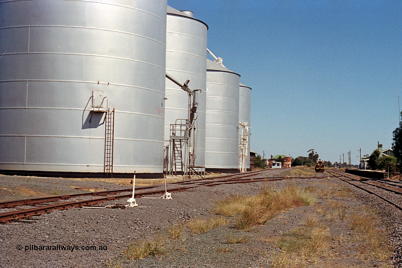 173-16
Murchison East, yard overview looking south, point levers, Ascom silo complex load-out spout with Murphy style silos and spout, Railway Hotel, track machines and the station platform and building.
