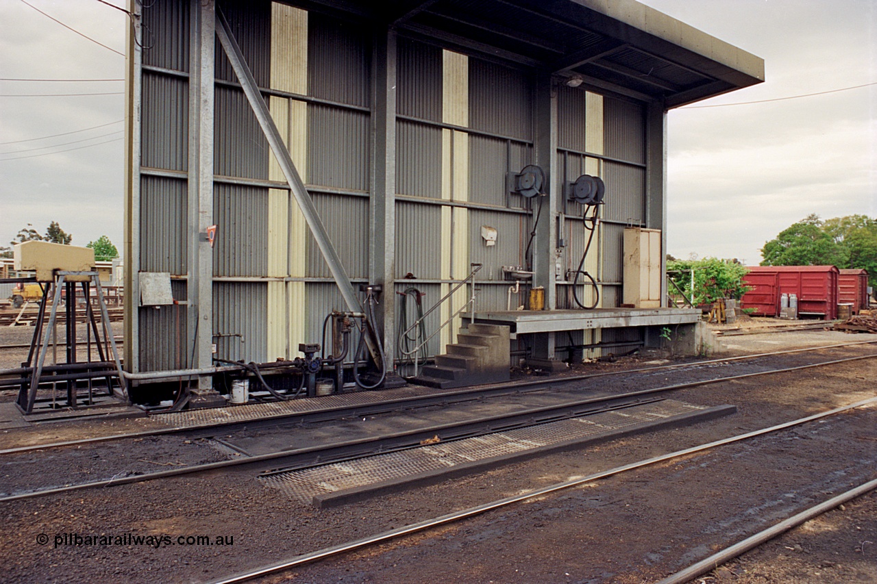 174-05
Wodonga, loco depot, fuel point canopy, showing fuel line and nozzle, hose reels etc. The grounded B vans in the background are for the examiners siding.
