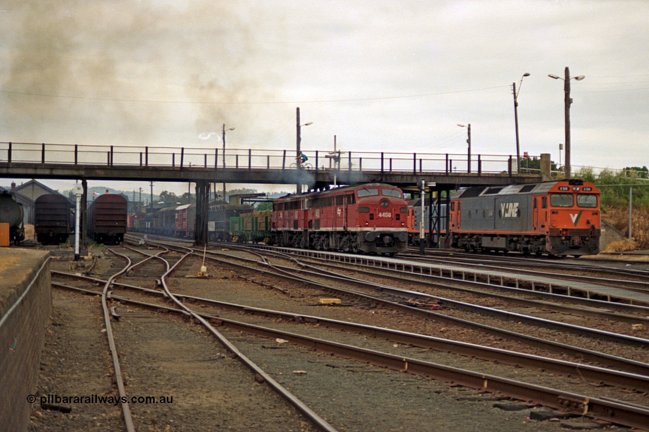 174-22
Albury, yard view from station dock area, NSWSRA standard gauge Red Terror liveried pair of 44 class 4456 AE Goodwin ALCo model DL500B serial 83746 and 4458 AE Goodwin ALCo model DL500B serial 83748 shunt the north with a Melbourne bound goods train, the broad gauge diamond is visible cutting across to the left.
Keywords: 44-class;4456;AE-Goodwin;ALCo;DL500B;83746;