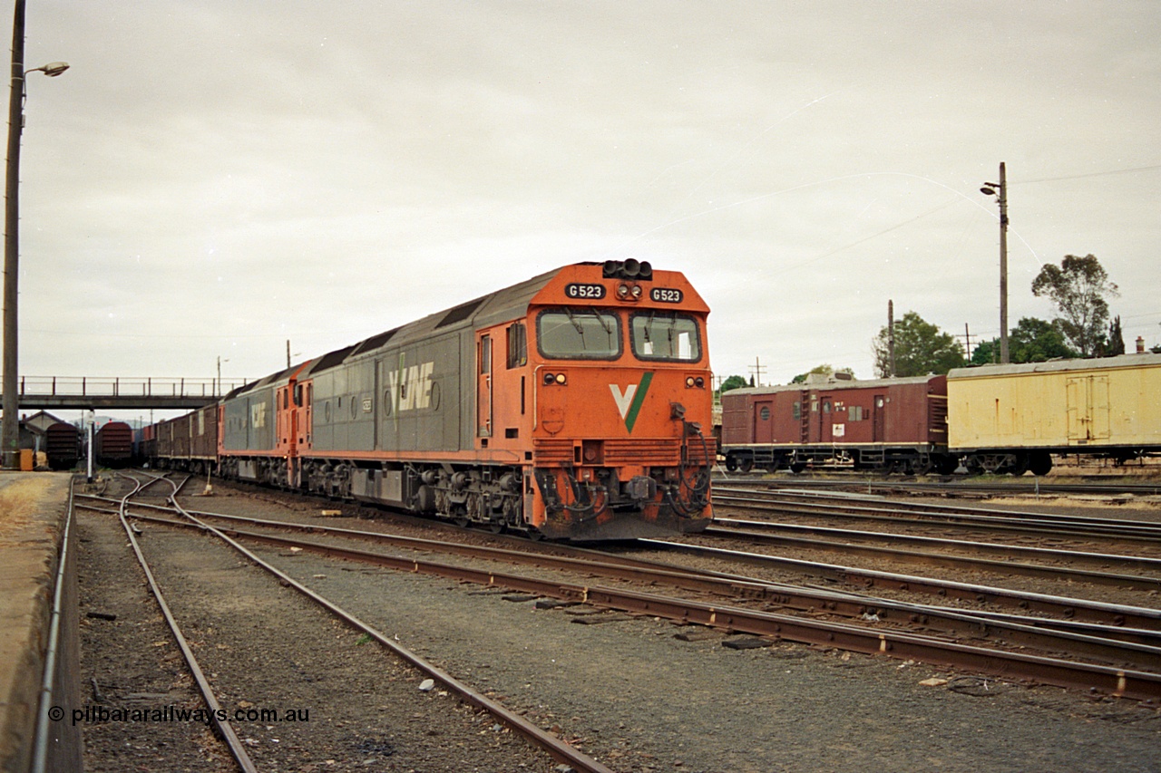 174-24
Albury, yard view from station dock area, V/Line standard gauge G class locomotives G 523 Clyde Engineering EMD model JT26C-2SS serial 86-1236 and a sister lead an up Melbourne bound goods train away from the north yard, the broad gauge track and diamond can be seen running across the dock road.
Keywords: G-class;G523;Clyde-Engineering-Rosewater-SA;EMD;JT26C-2SS;86-1236;
