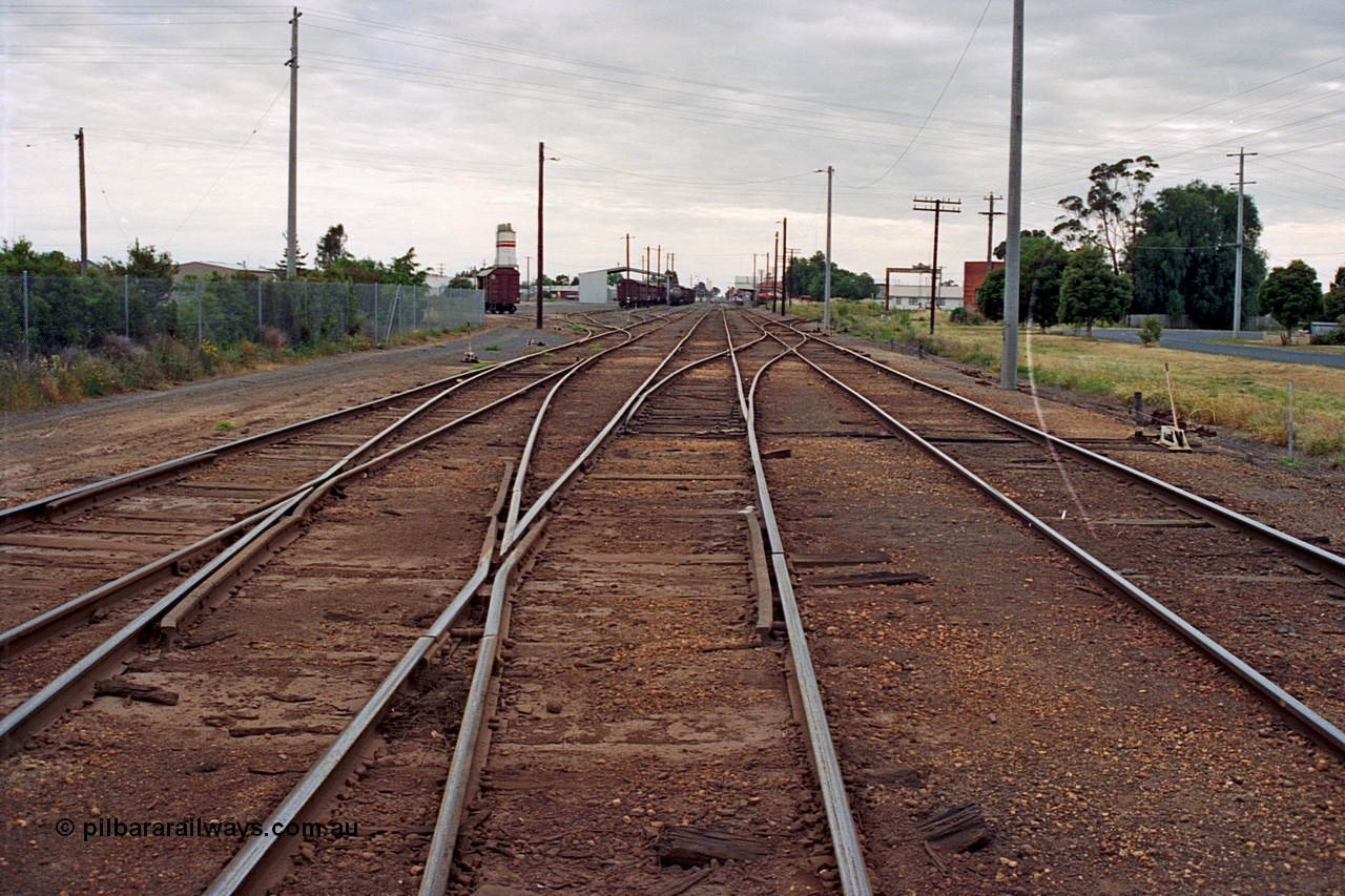 175-12
Shepparton station yard overview looking north, from No.2 Road or mainline, crossover from No.2 to No.1 Road leads into former weighbridge sidings, yard roads 3, 4 and 5 visible at left, also location of cement silos and Freight Gate canopy, station in the distance on the right.
