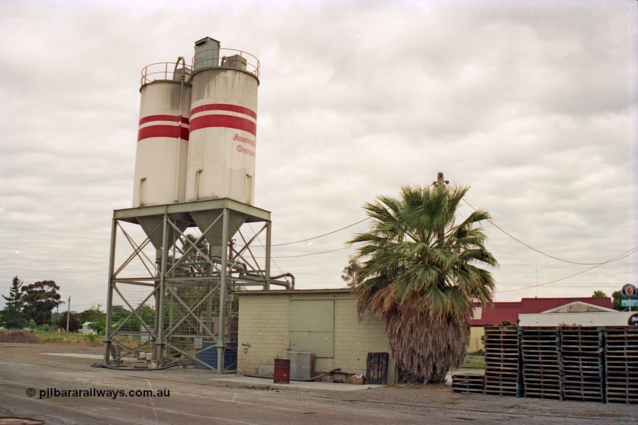175-16
Shepparton, rail served industry, Australian Cement, waggon unloading area, elevation of storage silos and structure arrangement, with brick control building, pallet stacks.
