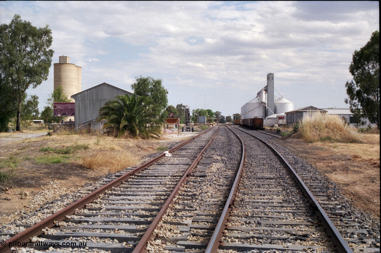 176-06
Yarrawonga station yard overview looking south, super phosphate shed and Williamstown style silo complex on the left, station building and platform in the middle distance, and GEB sub-terminal silo complex on the right.
