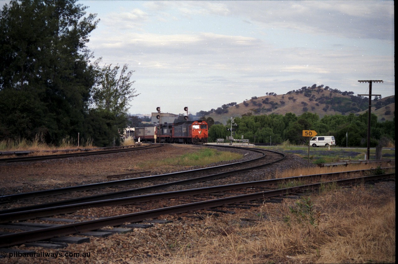 176-09
Wodonga, V/Line standard gauge up goods train passing the Wodonga Coal Sidings behind the G class G 524 Clyde Engineering EMD model JT26C-2SS serial 86-1237 and C class C 505 Clyde Engineering EMD model GT26C serial 76-828 combination, broad gauge track on the left, and the former broad gauge line to Bandiana and Cudgewa curving around to the right.
Keywords: G-class;G524;Clyde-Engineering-Rosewater-SA;EMD;JT26C-2SS;86-1237;