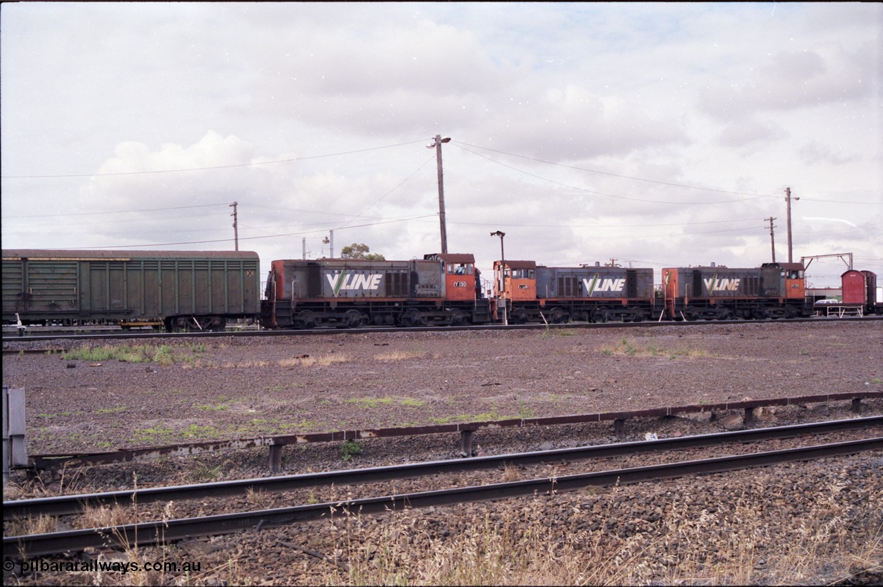 177-03
Tottenham Yard, view from standard gauge mainline of broad gauge Clyde Engineering EMD model G6B, V/Line shunt locomotives of the Y class, Y 130 serial 65-396 with a green louvre van and Y 118 serial 63-308 and Y 171 serial 68-591 as they go about Saturday morning shunting duties. In the final years of V/Line operation, the Y class were operated in pairs to shunt Tottenham Yard.
Keywords: Y-class;Y130;Clyde-Engineering-Granville-NSW;EMD;G6B;65-396;