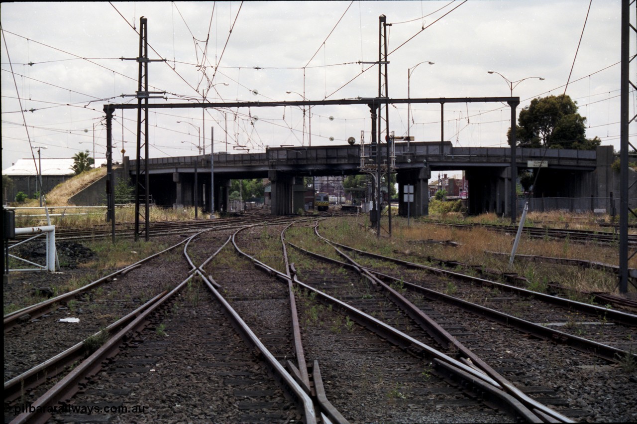 177-10
Newport station and yard overview taken from the workshops roads, Williamstown lines are at the right, I'm standing at the Newport Workshops No.1 and No.2 double track junction, the lines to Geelong are on the left beyond the white gate, a Comeng electric set is at the platform with the overbridge carrying Melbourne Road.
