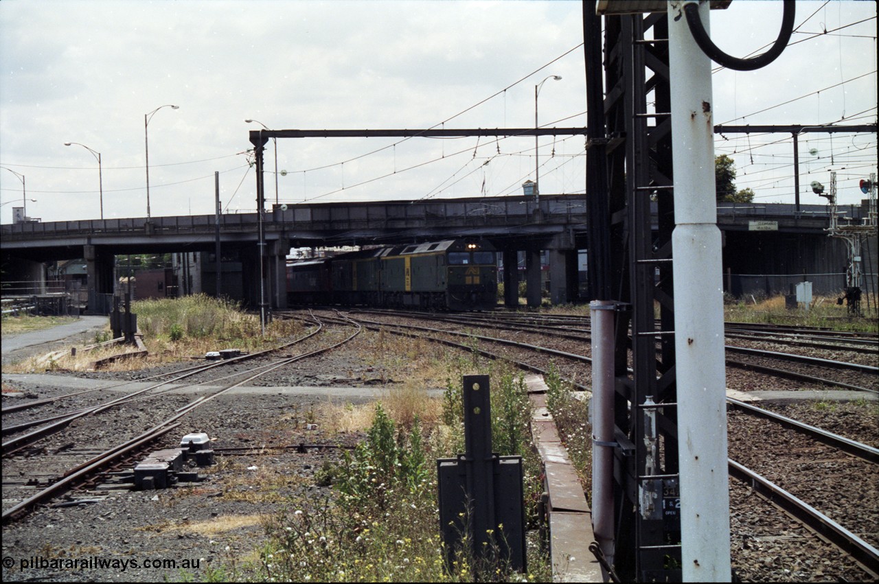 177-13
Newport, looking towards Melbourne, V/Line broad gauge down goods train 9169 creeps under the Melbourne Road overpass behind a pair of Australian National BL class locomotives, with a V/Line S and X class rounding out the motive power.
Keywords: BL-class;BL27;Clyde-Engineering-Rosewater-SA;EMD;JT26C-2SS;83-1011;