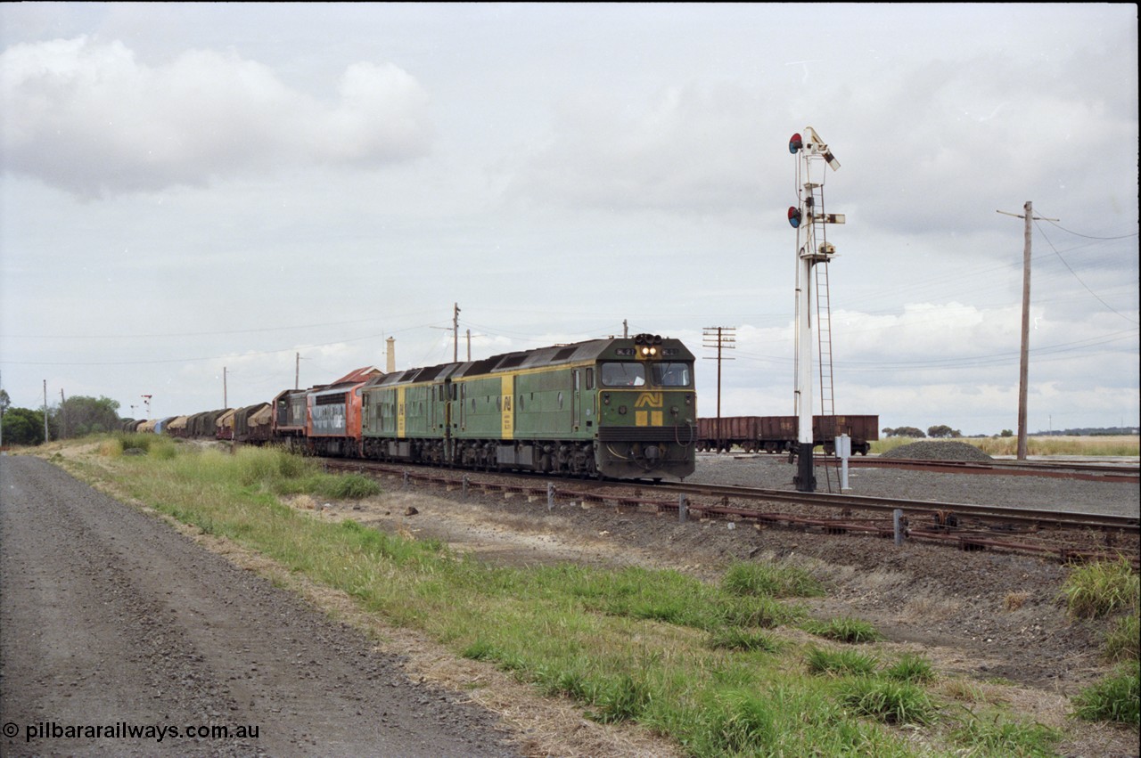 177-24
Gheringhap, down V/Line broad gauge goods train to Adelaide 9169 gets under way towards Ararat via Cressy with semaphore signal post 4 pulled off for the Cressy line, with power of the quad combo of a pair of Australian National BL class locomotives BL 27 Clyde Engineering EMD model JT26C-2SS serial 83-1011 and class leader BL 26 'Bob Hawke' serial 83-1010 and V/Line S class S 313 'Alfred Deakin' Clyde Engineering EMD model A7 serial 61-230 and X class X 53 Clyde Engineering EMD model G26C serial 75-800, BL 27 had Paul Keating drawn on the LHS cab as it was just after he'd taken the Labor Party leadership and the Prime Ministership off Bob Hawke.
Keywords: BL-class;BL27;Clyde-Engineering-Rosewater-SA;EMD;JT26C-2SS;83-1011;