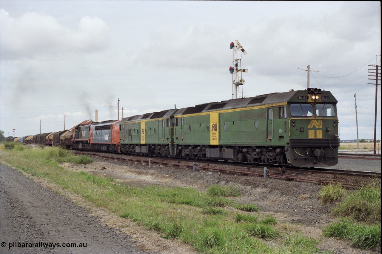 177-25
Gheringhap, down V/Line broad gauge goods train to Adelaide 9169 gets under way towards Ararat via Cressy with semaphore signal post 4 pulled off for the Cressy line, with power of the quad combo of a pair of Australian National BL class locomotives BL 27 Clyde Engineering EMD model JT26C-2SS serial 83-1011 and class leader BL 26 'Bob Hawke' serial 83-1010 and V/Line S class S 313 'Alfred Deakin' Clyde Engineering EMD model A7 serial 61-230 and X class X 53 Clyde Engineering EMD model G26C serial 75-800, BL 27 had Paul Keating drawn on the LHS cab as it was just after he'd taken the Labor Party leadership and the Prime Ministership off Bob Hawke.
Keywords: BL-class;BL27;Clyde-Engineering-Rosewater-SA;EMD;JT26C-2SS;83-1011;