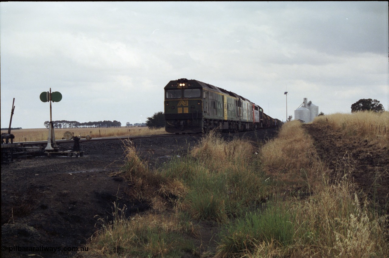 178-08
Tatyoon, down V/Line broad gauge goods train to Adelaide 9169 powers through the loop heading for Ararat with the quad combo of a pair of Australian National BL class locomotives BL 27 Clyde Engineering EMD model JT26C-2SS serial 83-1011 and class leader BL 26 'Bob Hawke' serial 83-1010 and V/Line S class S 313 'Alfred Deakin' Clyde Engineering EMD model A7 serial 61-230 and X class X 53 Clyde Engineering EMD model G26C serial 75-800, BL 27 had Paul Keating drawn on the LHS cab as it was just after he'd taken the Labor Party leadership and the Prime Ministership off Bob Hawke.
Keywords: BL-class;BL27;Clyde-Engineering-Rosewater-SA;EMD;JT26C-2SS;83-1011;