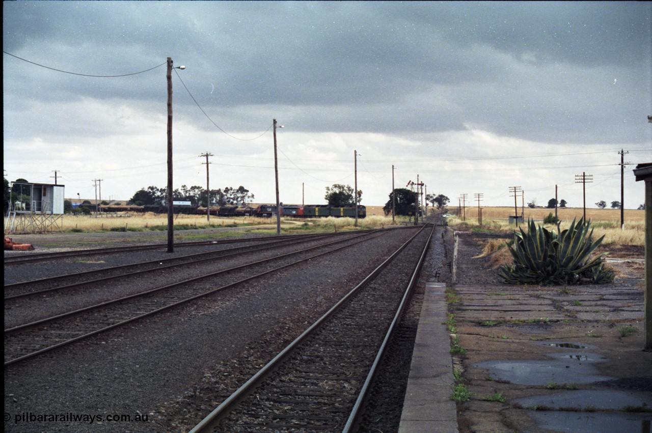 178-11
Maroona, station yard overview looking towards Portland from the platform as V/Line's down Adelaide goods train 9169 swings off the Cressy line behind with the quad combo of a pair of Australian National BL class locomotives BL 27 Clyde Engineering EMD model JT26C-2SS serial 83-1011 and class leader BL 26 'Bob Hawke' serial 83-1010 and V/Line S class S 313 'Alfred Deakin' Clyde Engineering EMD model A7 serial 61-230 and X class X 53 Clyde Engineering EMD model G26C serial 75-800.
