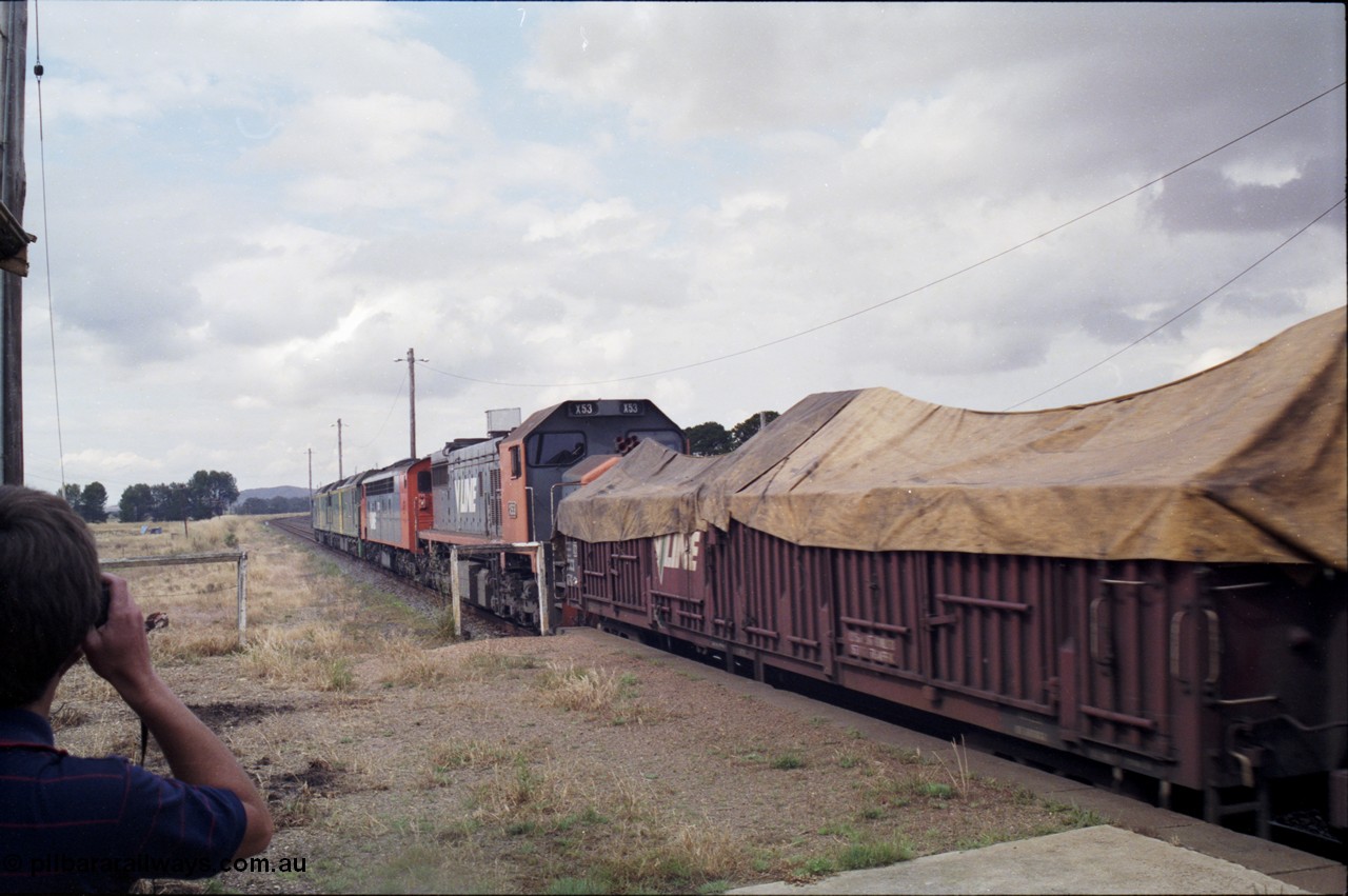 178-14
Maroona, station platform, the quad combo of a pair of Australian National BL class locomotives BL 27 Clyde Engineering EMD model JT26C-2SS serial 83-1011 and class leader BL 26 'Bob Hawke' serial 83-1010 and V/Line S class S 313 'Alfred Deakin' Clyde Engineering EMD model A7 serial 61-230 and X class X 53 Clyde Engineering EMD model G26C serial 75-800 leads V/Line down goods train 9169 to Adelaide as it heads for Ararat.
