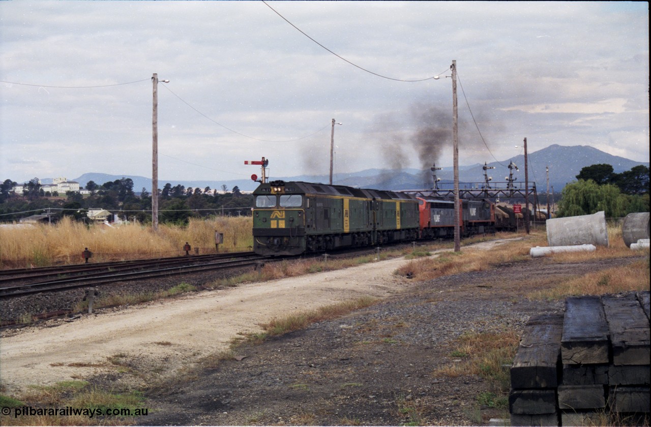 178-16
Ararat, track view looking east as V/Line broad gauge goods train 9169 to Adelaide powers up along the mainline off the Portland line under the signal gantry with semaphore signal post 4 pulled off behind Australian National BL class locomotives BL 27 Clyde Engineering EMD model JT26C-2SS serial 83-1011 and class leader BL 26 'Bob Hawke' serial 83-1010 and V/Line S class S 313 'Alfred Deakin' Clyde Engineering EMD model A7 serial 61-230 and X class X 53 Clyde Engineering EMD model G26C serial 75-800, taken from the former Works and Cattle Sidings area, the Aradale Asylum is in the background.
Keywords: BL-class;BL27;Clyde-Engineering-Rosewater-SA;EMD;JT26C-2SS;83-1011;