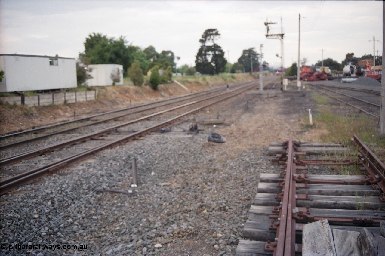 178-22
Ballarat East, track view looking towards Warrenheip with a down goods train on approach, the shot if off focus but the area is being re-signalled from mechanical to electric, with a new set of points to go in and a new electric light signal to replace the mechanical post No.3, Ballarat East loco depot is on the right.
