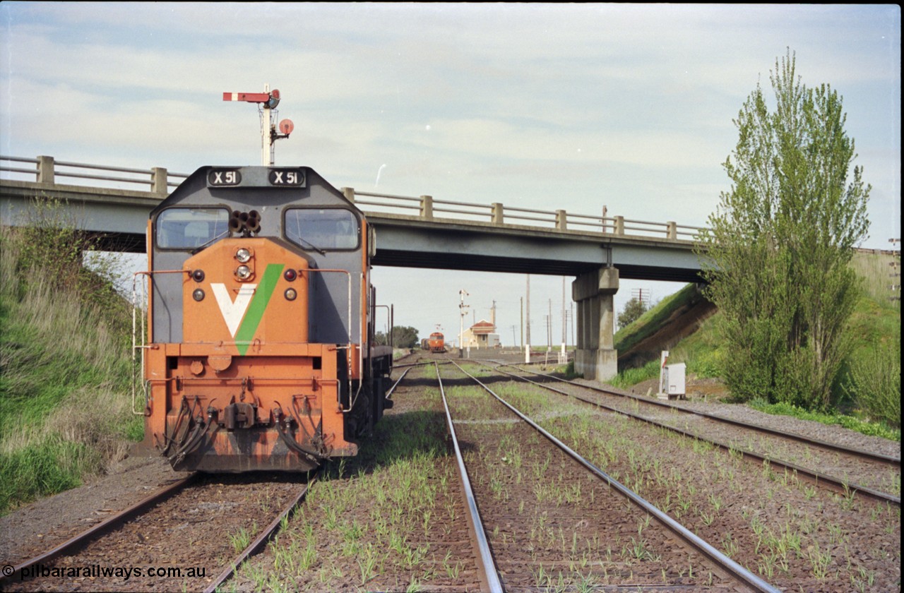 179-20
Gheringhap, station yard overview looking east from the Ballarat line and Siding C, the line to Maroona is on the right, in the back ground semaphore signal post 4 is pulled of for down goods train 9169 to depart, V/Line broad gauge X class locomotive X 51 Clyde Engineering EMD model G26C serial 75-798 is awaiting light engines from Geelong to come and retrieve it.
Keywords: X-class;X51;Clyde-Engineering-Rosewater-SA;EMD;G26C;75-798;