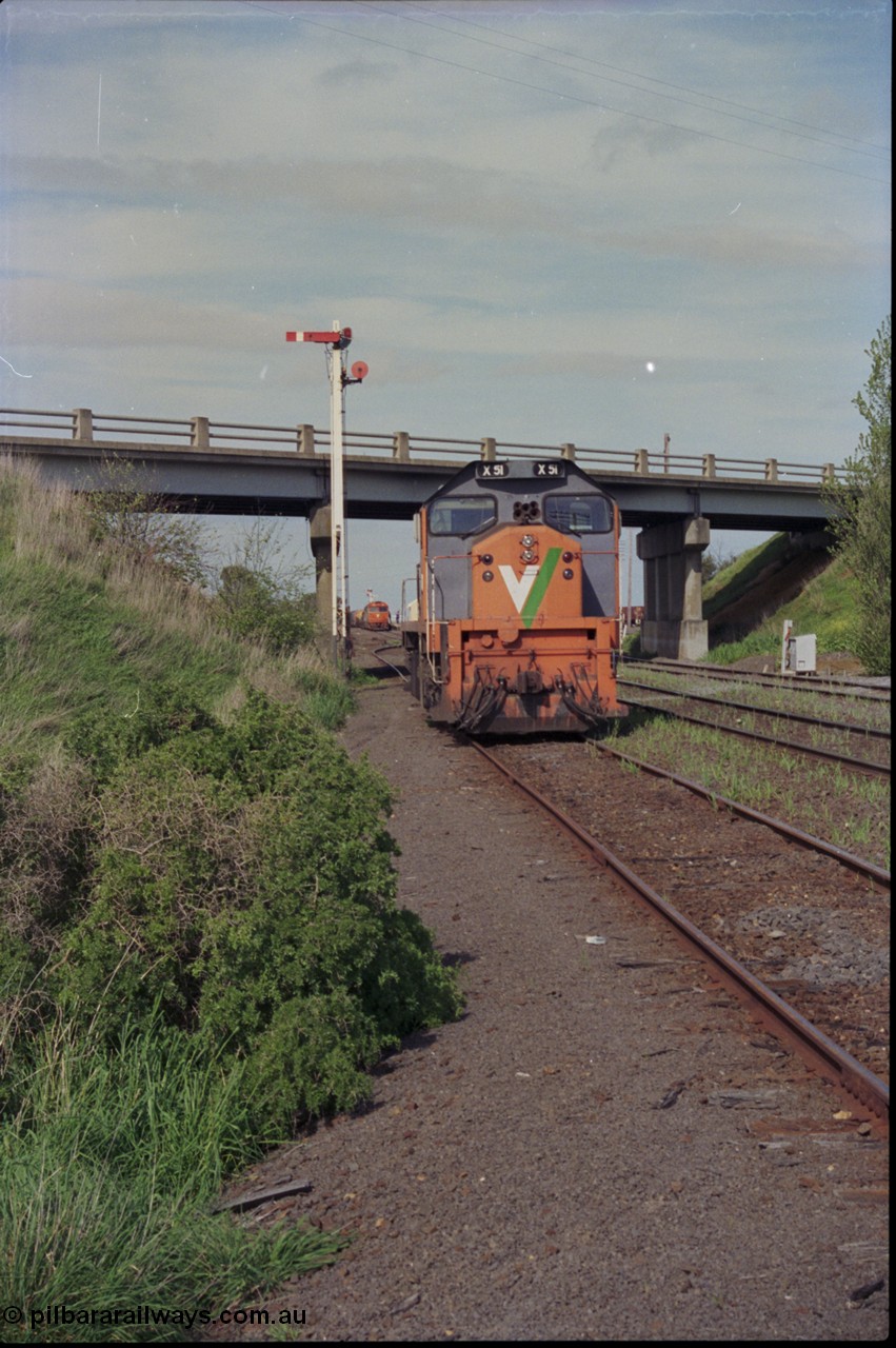 179-22
Gheringhap, station yard overview looking east from Siding C, past V/Line broad gauge X class locomotive X 51 Clyde Engineering EMD model G26C serial 75-798 that is awaiting light engines from Geelong to come and retrieve it and semaphore signal post 5, down goods train 9169 is about to depart in the background.
Keywords: X-class;X51;Clyde-Engineering-Rosewater-SA;EMD;G26C;75-798;