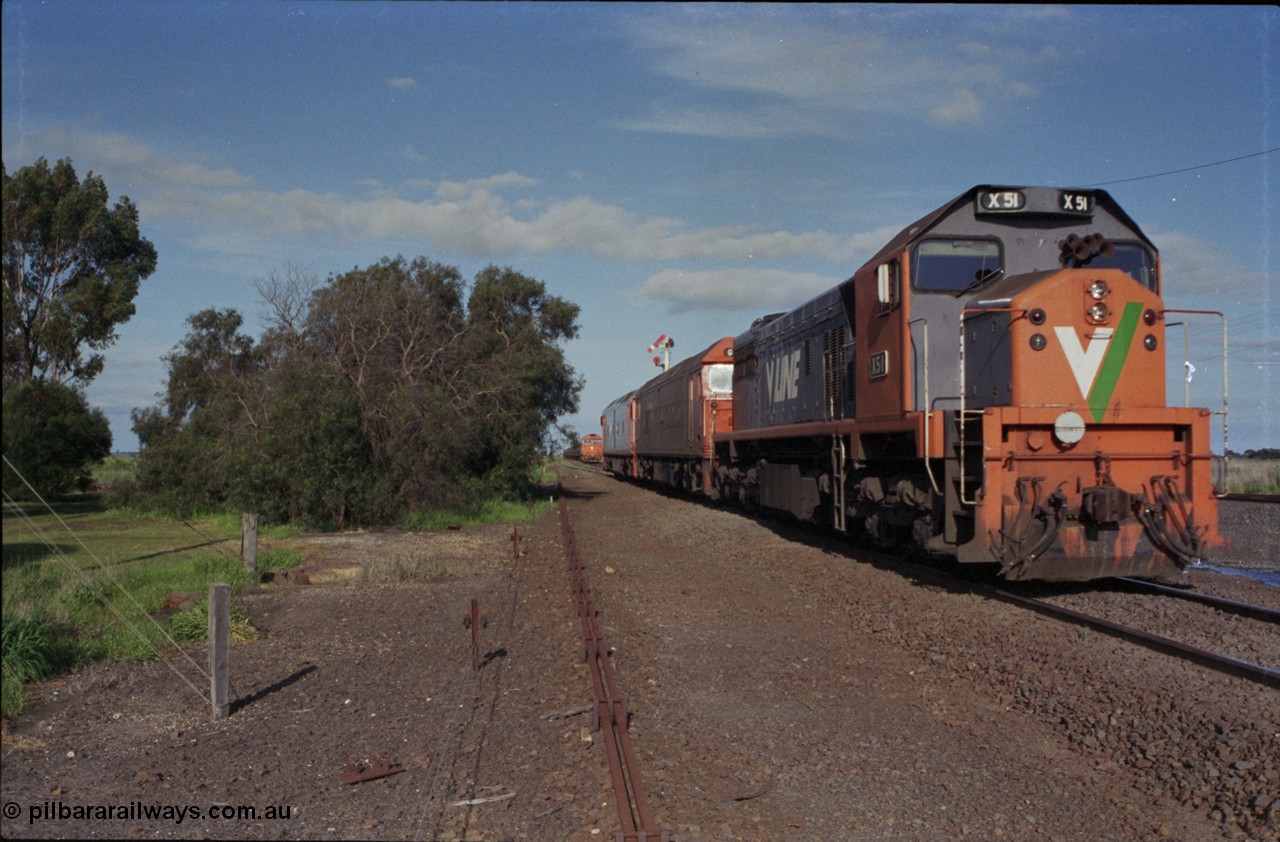 179-37
Gheringhap, track view looking east towards Geelong from the former up platform see V/Line broad gauge light engines departing for North Geelong C with failed X class X 50 Clyde Engineering EMD model G26C serial 75-797 which was taken of 9169 down goods, locked away down grain train 9121 can be seen in Siding A awaiting line clear and semaphore signal post is pulled off for the move.
Keywords: X-class;X51;Clyde-Engineering-Rosewater-SA;EMD;G26C;75-798;