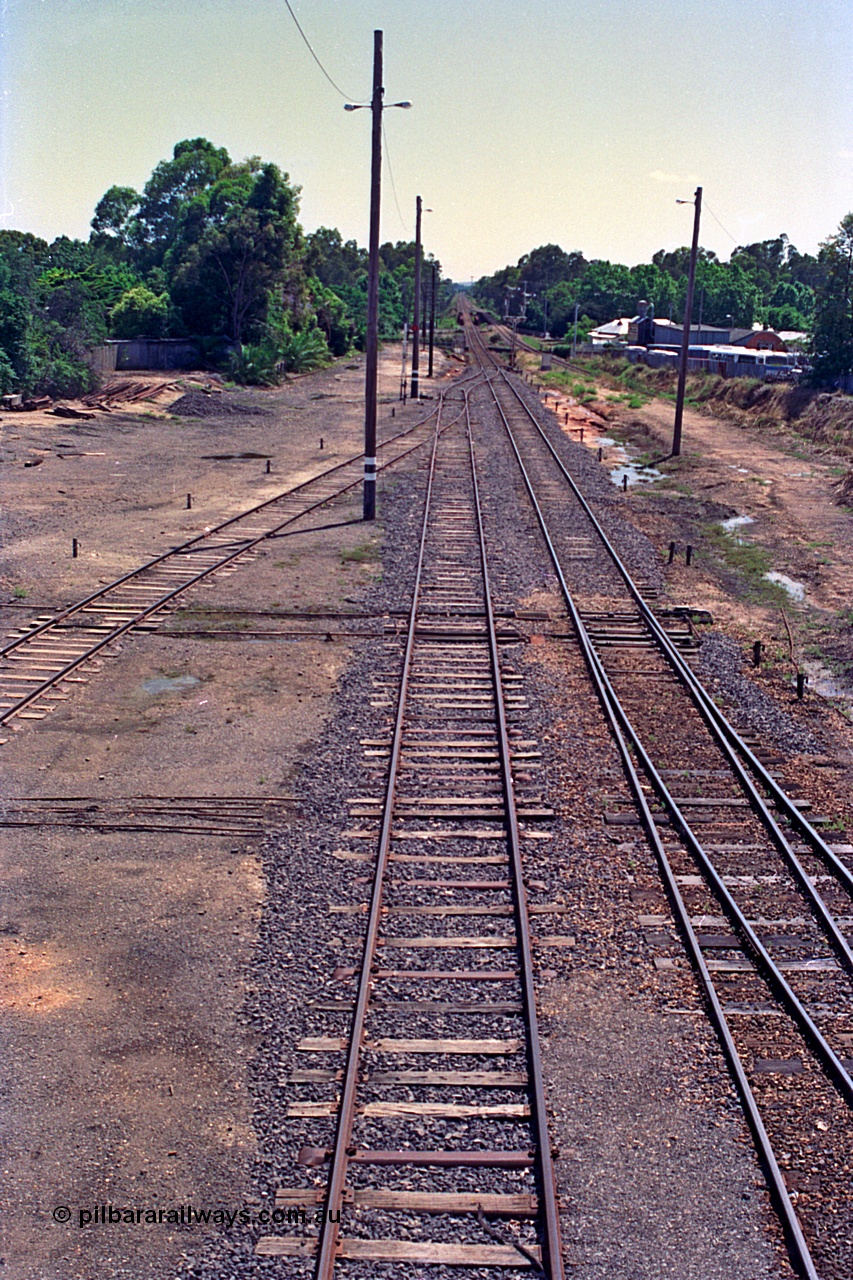 180-11
Wangaratta, rationalised yard view looking north from footbridge, shows steel sleepers in newly extended No.3 Road (originally Siding C) which now joins the mainline in the distance, with the relocated signal post No.23 also just visible, No.4 Road joins in from the left, which was originally 5 Road but 4 Road was also removed along with the sidings that used to be on the left of the image..
