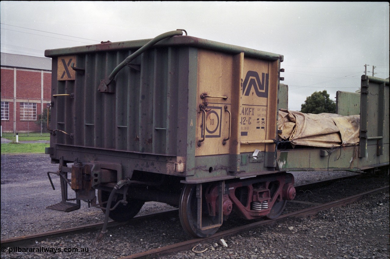 181-09
Trafalgar yard, loaded Australian National AKFX type bogie steel waggon AKFX 12, in AN green and yellow livery, number board view.
Keywords: AKFX-type;AKFX12;