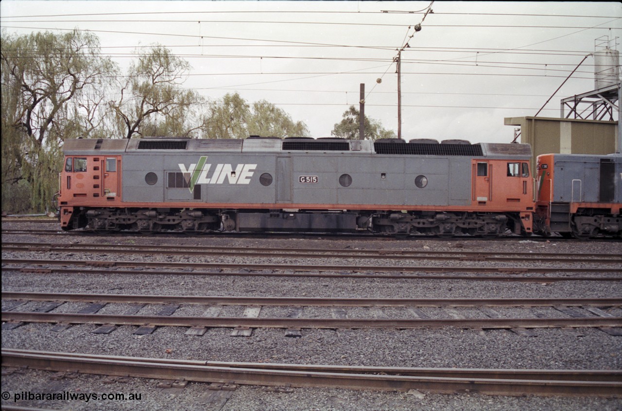 181-12
Traralgon loco depot, V/Line broad gauge loco G class G 515 Clyde Engineering EMD model JT26C-2SS serial 85-1243, side view, coupled to a T class.
Keywords: G-class;G515;Clyde-Engineering-Rosewater-SA;EMD;JT26C-2SS;85-1243;