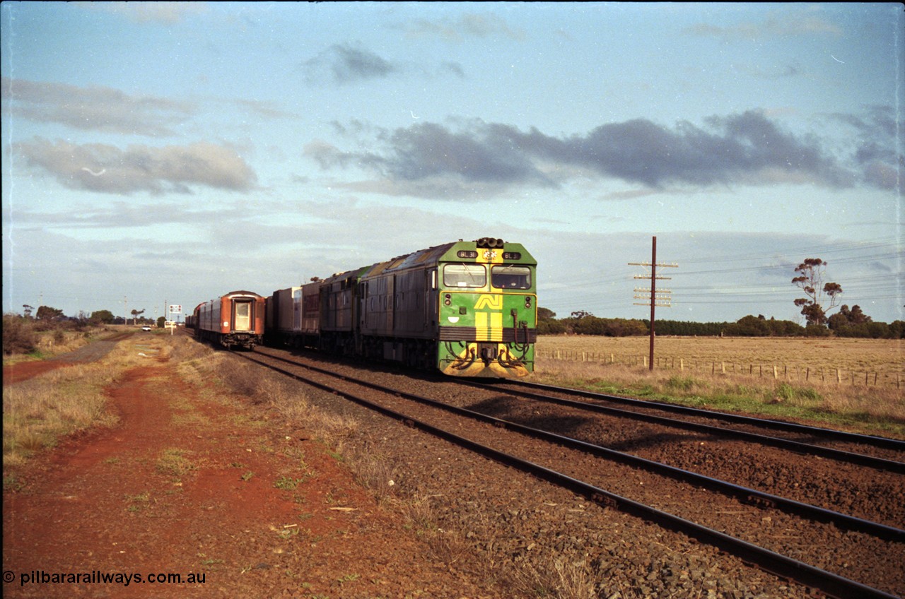 183-08
Rockbank, an Adelaide bound down broad gauge goods train behind Australian National BL class BL 31 Clyde Engineering EMD model JT26C-2SS serial 83-1015 and 700 class 705 AE Goodwin ALCo model DL500G serial G6059-3 as an up V/Line passenger train runs through on the loop.
Keywords: BL-class;BL31;Clyde-Engineering-Rosewater-SA;EMD;JT26C-2SS;83-1015;