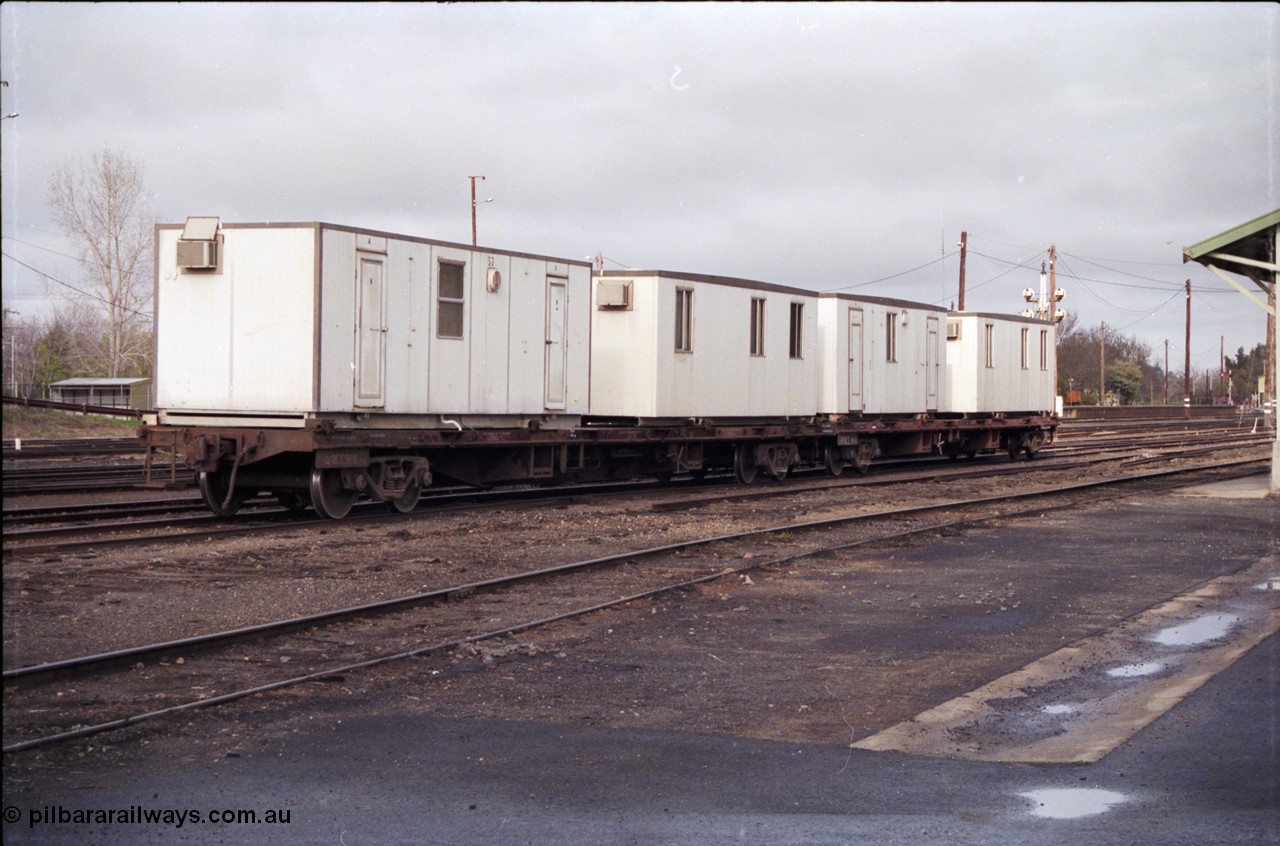 183-16
Benalla, yard view, V/Line broad gauge VQCX type 60 foot bogie container waggons VQCX 968 which was built new by Victorian Railways Ballarat North Workshops in April 1980 and another loaded with workman's dongers, or accommodation blocks, the yard is being rationalised.
Keywords: VQCX-type;VQCX968;Victorian-Railways-Ballarat-Nth-WS;