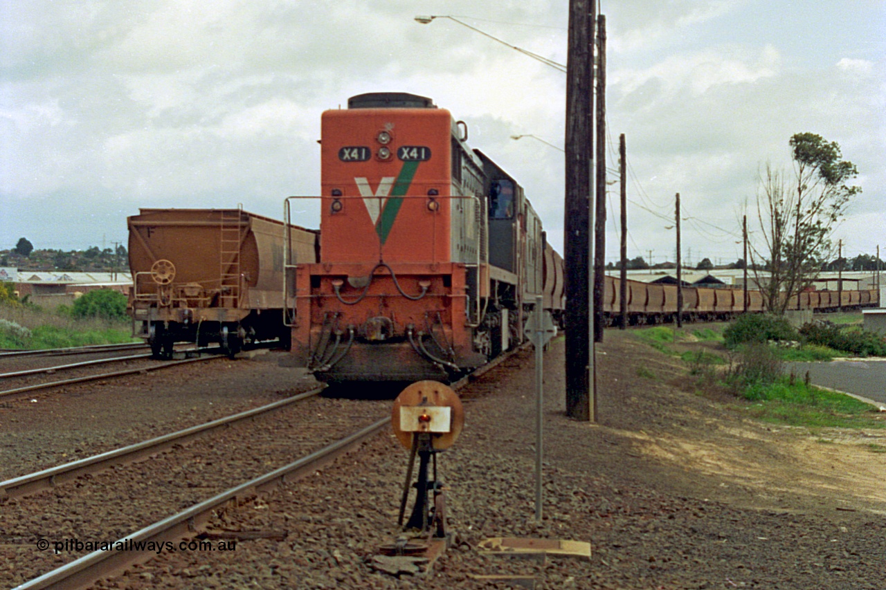 185-03
North Geelong grain arrivals, V/Line X class locomotive X 41 Clyde Engineering EMD model G26C serial 70-704 long end leading prepares a loaded grain rake bound for the grain loop unloader, ground dwarf disc signal 14, with another loaded grain on the left.
Keywords: X-class;X41;Clyde-Engineering-Granville-NSW;EMD;G26C;70-704;