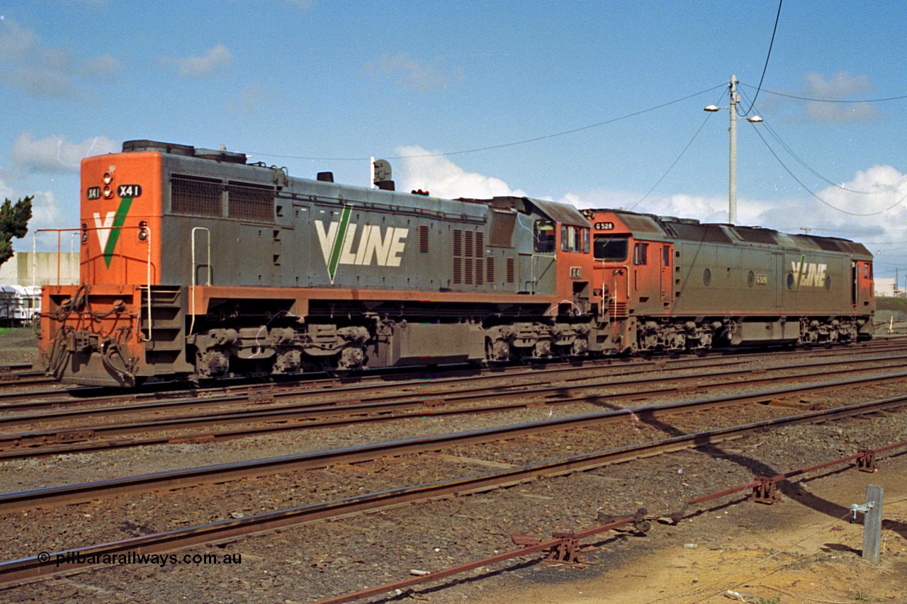 185-15
North Geelong Yard, V/Line grain loop shunt engines X class locomotive X 41 Clyde Engineering EMD model G26C serial 70-704 long end leading and G class locomotive G 528 Clyde Engineering EMD model JT26C-2SS serial 88-1258 stand in the yard awaiting the road to the arrivals to collect another loaded grain consist.
Keywords: X-class;X41;Clyde-Engineering-Granville-NSW;EMD;G26C;70-704;