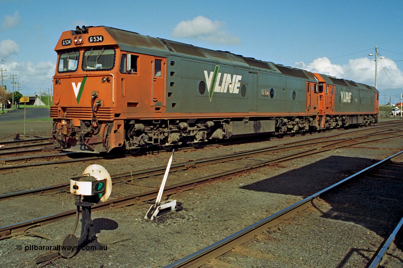 185-17
North Geelong C Box, V/Line light engines, G classes G 534 Clyde Engineering EMD model JT26C-2SS serial 88-1264 leads older sister and class leader G 511 serial 84-1239 as they shunt back into the Sorting Sidings to collect an empty grain train, ground dwarf signal post 18 and point lever for points from Through Road to No.1 Siding are in the foreground.
Keywords: G-class;G534;Clyde-Engineering-Somerton-Victoria;EMD;JT26C-2SS;88-1264;